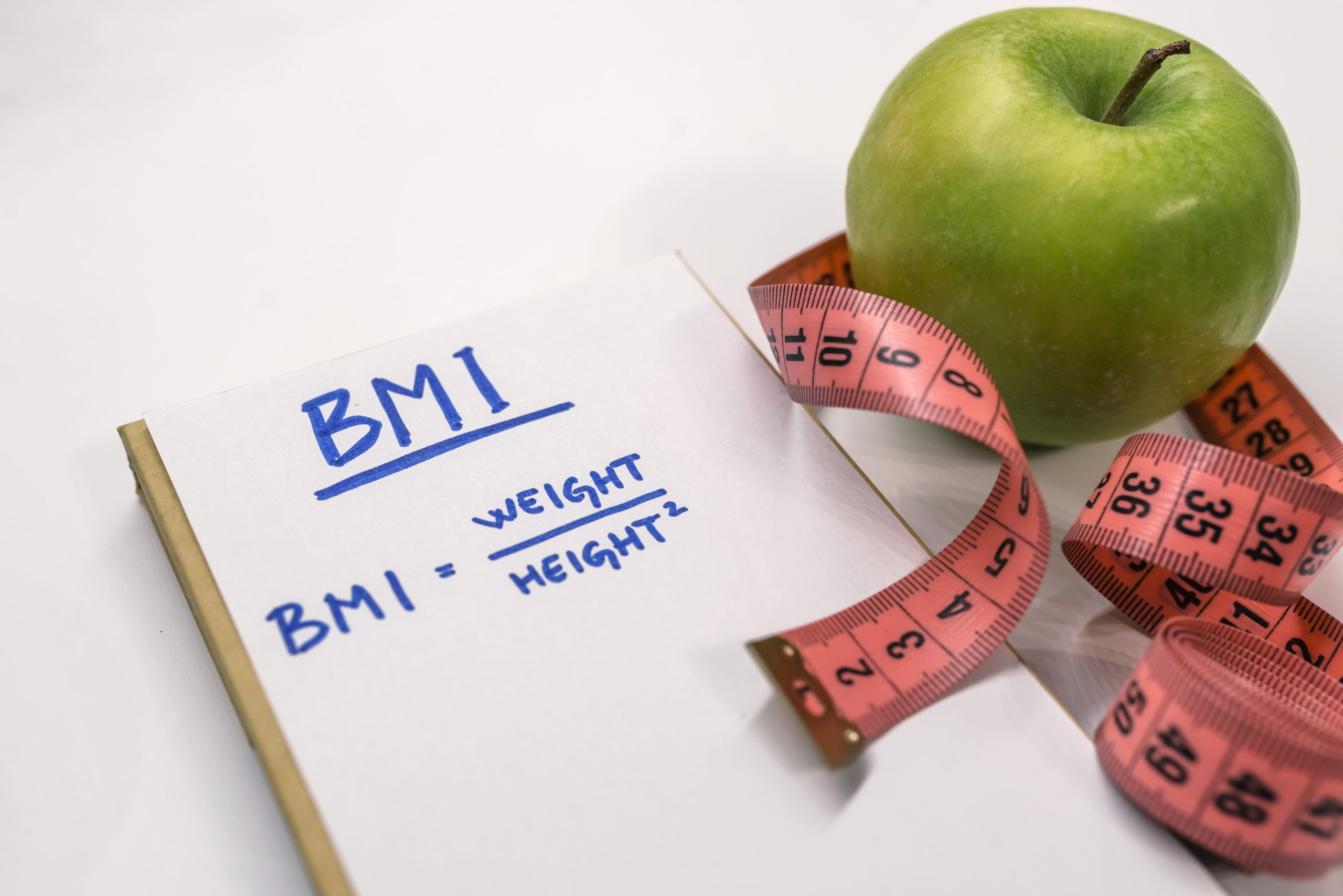 BMI notepad with measuring tape — healthy weight loss